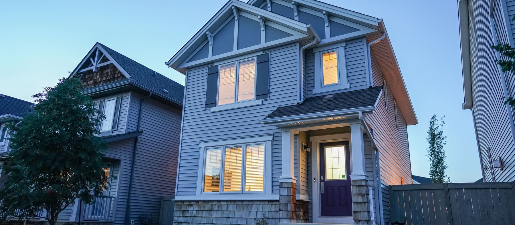 A house at dusk with the lights on