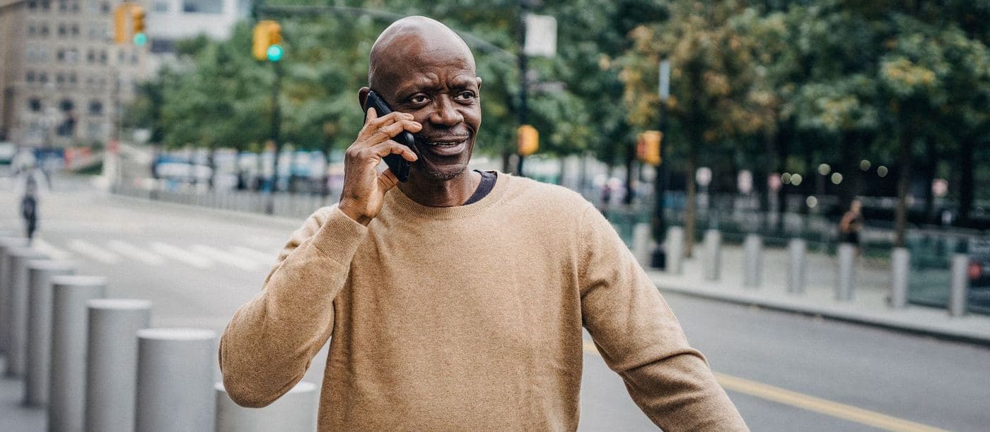 A man talking on the phone outdoors